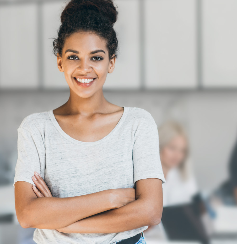 Portrait of female black engineer posing with arms crossed in office